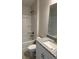 Well-lit bathroom featuring a granite countertop vanity, toilet, mirror, and a bathtub-shower combination at 2162 Nw 23Rd Loop, Ocala, FL 34475