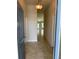 Inviting hallway with tile flooring, neutral paint, and a view of the front door and living area at 2162 Nw 23Rd Loop, Ocala, FL 34475
