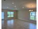 Spacious living room featuring neutral walls, ample natural light from two windows, and recessed lighting at 2162 Nw 23Rd Loop, Ocala, FL 34475