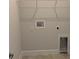 Well-lit utility room with a shelf, hookups for washer and dryer, and a door for pet access at 2162 Nw 23Rd Loop, Ocala, FL 34475