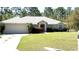 Charming single-story home featuring an attached two-car garage and a well-manicured front lawn at 21962 Sw Nautilus Blvd, Dunnellon, FL 34431
