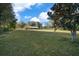 Large backyard with mature trees and grassy area at 2645 Se 162Nd Place Rd, Summerfield, FL 34491