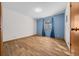 Simple bedroom with wood flooring and blue curtains at 2645 Se 162Nd Place Rd, Summerfield, FL 34491