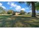 House with a large yard, mature trees, and a long driveway at 2645 Se 162Nd Place Rd, Summerfield, FL 34491