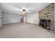 Living room featuring a brick fireplace, tile floors, and ceiling fan at 2645 Se 162Nd Place Rd, Summerfield, FL 34491