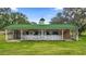 White barn with green metal roof and stall areas at 2883 Sw 66Th St, Ocala, FL 34476