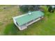 Aerial view of barn with green roof and white trim nestled in a lush green pasture at 2883 Sw 66Th St, Ocala, FL 34476