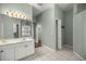 Double vanity bathroom with neutral colors and tiled floors at 2883 Sw 66Th St, Ocala, FL 34476