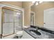 Bathroom features a marble countertop, gilded shower doors, and white cabinets at 2883 Sw 66Th St, Ocala, FL 34476