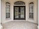 Elegant entryway with double doors, arched windows, and tile flooring at 2883 Sw 66Th St, Ocala, FL 34476