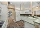 Bright kitchen featuring white cabinets, wood flooring, and ample counter space at 2883 Sw 66Th St, Ocala, FL 34476