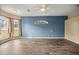 Spacious living room featuring wood-look floors and a calming blue accent wall at 2883 Sw 66Th St, Ocala, FL 34476