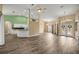 Spacious living room featuring hardwood floors, modern ceiling fan, and a view of the kitchen area at 2883 Sw 66Th St, Ocala, FL 34476