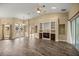 Bright living room featuring hardwood floors, a fireplace, and elegant glass-paneled front doors at 2883 Sw 66Th St, Ocala, FL 34476