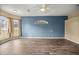 Open living room with wood-look flooring, modern ceiling fan, and bay windows that let in plenty of natural light at 2883 Sw 66Th St, Ocala, FL 34476