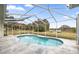 Inviting kidney-shaped pool with screened enclosure, offering ample outdoor enjoyment at 2883 Sw 66Th St, Ocala, FL 34476