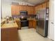 Kitchen features stainless steel appliances and ample cabinetry at 4036 Sw 57Th Ct, Ocala, FL 34474