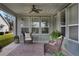 Relaxing back patio with wicker chairs and a ceiling fan at 4775 Nw 35Th Lane Rd, Ocala, FL 34482