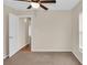 Bedroom with carpet, ceiling fan and door to hallway at 4945 Nw 33Rd Ln, Ocala, FL 34482