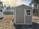 Tan shed with white trim located in the backyard at 5242 Sw 162Nd Place Rd, Ocala, FL 34473