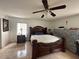 Spacious bedroom with a large bed and ceiling fan at 5242 Sw 162Nd Place Rd, Ocala, FL 34473