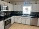 Kitchen with stainless steel appliances and white cabinets at 5242 Sw 162Nd Place Rd, Ocala, FL 34473