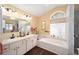 Bathroom boasts double vanities and a relaxing soaking tub at 5470 Nw 26Th Lane, Ocala, FL 34482