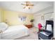 Guest bedroom with a ceiling fan and window at 5470 Nw 26Th Lane, Ocala, FL 34482