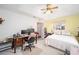 Bedroom with queen bed, desk and ceiling fan at 5470 Nw 26Th Lane, Ocala, FL 34482