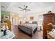 Spacious main bedroom with a leopard print comforter and ceiling fan at 5470 Nw 26Th Lane, Ocala, FL 34482