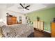 Main bedroom with dark wood furniture and ceiling fan at 5470 Nw 26Th Lane, Ocala, FL 34482