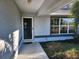 Front entrance with storm door and walkway at 6 Hickory Loop Way, Ocala, FL 34472