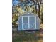 Grey storage shed with double doors in the backyard at 6 Hickory Loop Way, Ocala, FL 34472