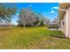 Large backyard with grassy area and mature trees at 6151 Sw 84Th St, Ocala, FL 34476