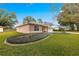 One-story house with a well-manicured lawn and lush landscaping at 6151 Sw 84Th St, Ocala, FL 34476