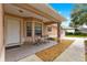 Small front porch with a table and chairs, next to the front door at 6151 Sw 84Th St, Ocala, FL 34476