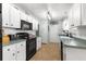 Modern kitchen with white cabinets and black appliances at 6151 Sw 84Th St, Ocala, FL 34476