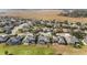 Aerial view of a residential neighborhood with houses near a golf course and marsh at 6839 Sw 97Th Terrace Rd, Ocala, FL 34481