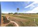 Landscaped backyard offering serene views of a golf course and pond at 6839 Sw 97Th Terrace Rd, Ocala, FL 34481