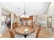 Bright dining area with wood flooring and a table for four, adjacent to the kitchen at 6839 Sw 97Th Terrace Rd, Ocala, FL 34481