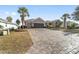 Single-story home with paver driveway and lush landscaping at 6839 Sw 97Th Terrace Rd, Ocala, FL 34481