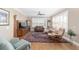 Living room with hardwood floors, comfy seating, and plantation shutters at 6839 Sw 97Th Terrace Rd, Ocala, FL 34481