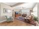 Living room with hardwood floors, comfortable seating, and plantation shutters at 6839 Sw 97Th Terrace Rd, Ocala, FL 34481