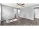 Spacious bedroom with wood-look floors and ceiling fan at 7084 Se 124 St, Belleview, FL 34420