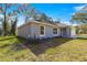 Single-story home with gray siding and landscaped yard at 7084 Se 124 St, Belleview, FL 34420