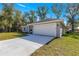 House exterior with a white garage door and driveway at 7084 Se 124 St, Belleview, FL 34420