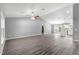 Spacious living room featuring a grey wall, hardwood floors and an open floor plan at 7084 Se 124 St, Belleview, FL 34420