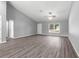 Large living area with grey walls, vinyl plank flooring, and an open layout at 7084 Se 124 St, Belleview, FL 34420