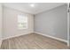 Bright bedroom with gray accent wall and wood-look flooring at 7402 Sw 99Th Ave, Ocala, FL 34481