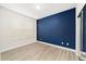 Bedroom with a blue accent wall and wood-look flooring at 7402 Sw 99Th Ave, Ocala, FL 34481